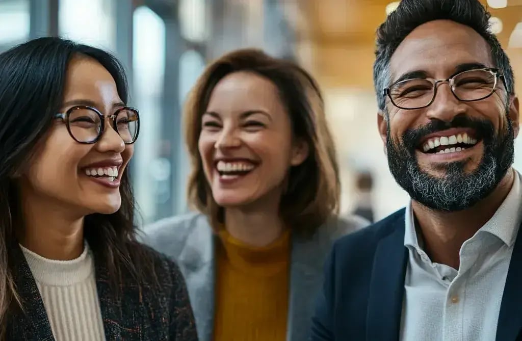 Two women and a man smiling-1